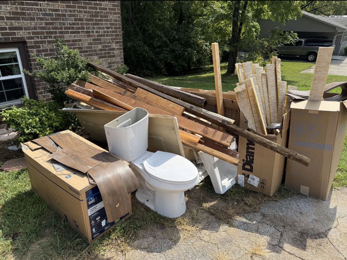 Construction debris lumber toilet and boxes ready for hauling