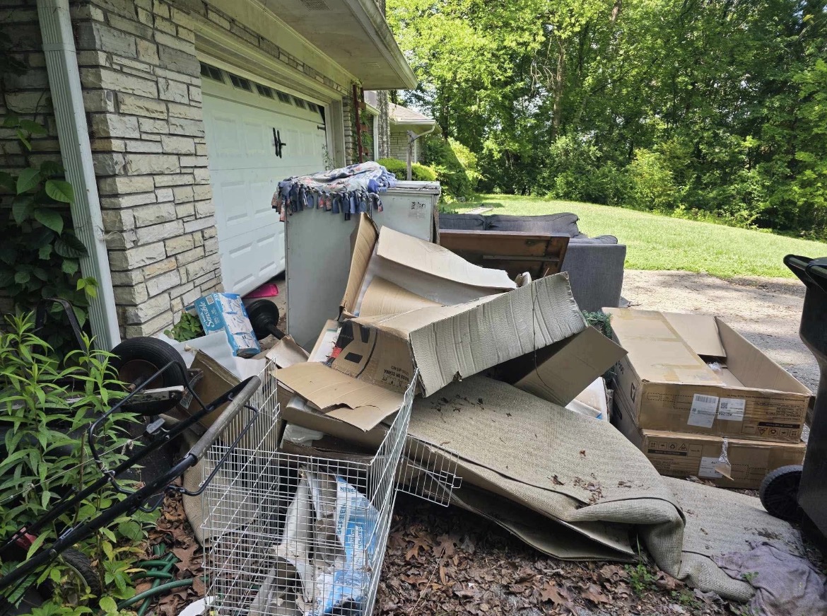 Garage cleanout pile with boxes furniture and household items